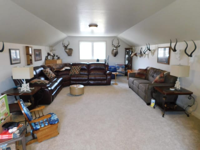 living area featuring lofted ceiling and carpet flooring