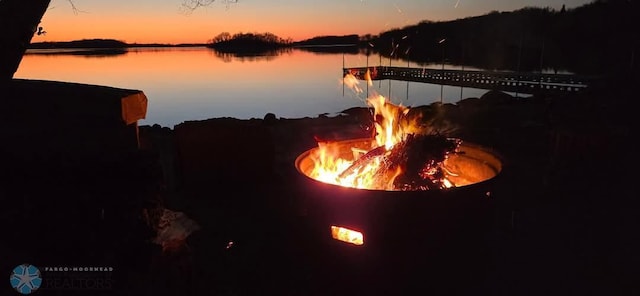 property view of water with an outdoor fire pit