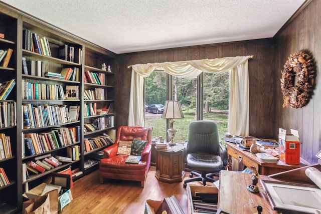 4810 Marystone Blvd NW, Andover, MN 55304 - home office featuring wooden walls, a textured ceiling, wood finished floors, and bookshelves