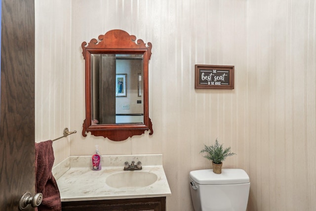 4810 Marystone Blvd NW, Andover, MN 55304 - half bathroom featuring vanity, toilet, and wallpapered walls