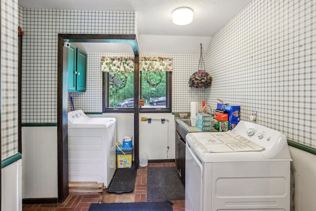 4810 Marystone Blvd NW, Andover, MN 55304 - laundry room with brick patterned floors, washing machine and clothes dryer, wallpapered walls, baseboards, and cabinet space