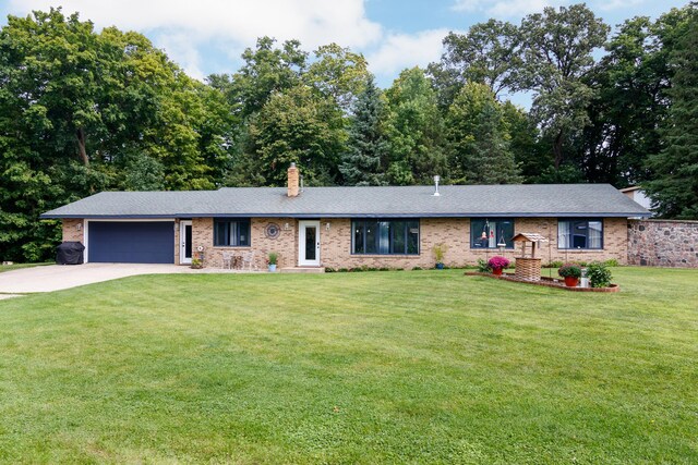 ranch-style house with a chimney, brick siding, a garage, driveway, and a front lawn
