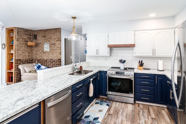 kitchen featuring white cabinetry, light wood-style flooring, a sink, stainless steel appliances, and blue cabinets