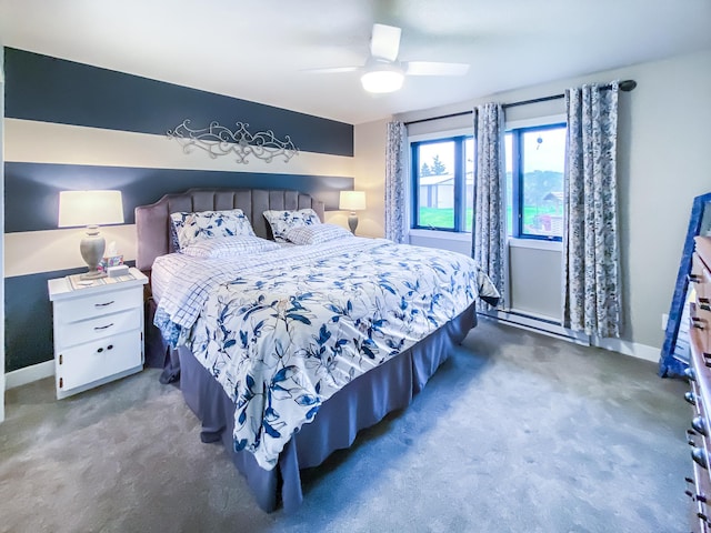 bedroom with a baseboard heating unit, a ceiling fan, carpet floors, and baseboards