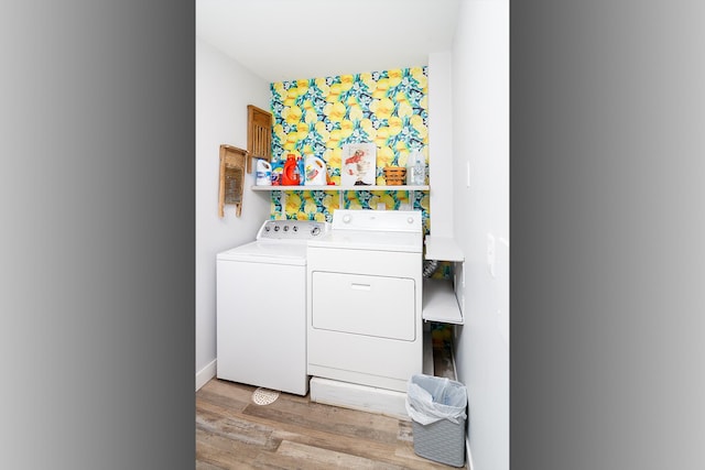 laundry room with washer and clothes dryer, laundry area, and light wood-style flooring