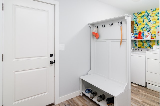 mudroom featuring washing machine and dryer and light wood-type flooring
