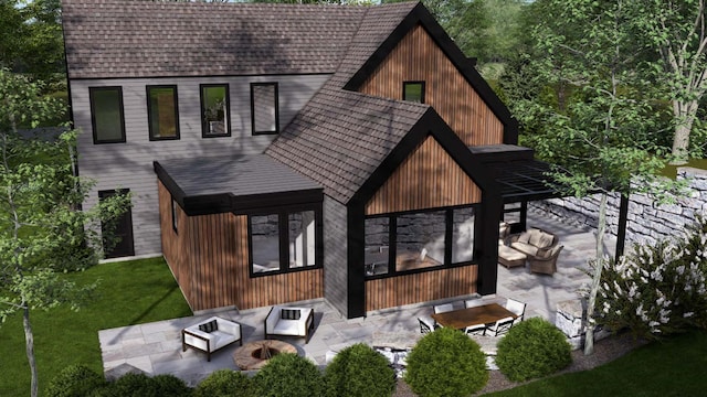 rear view of house featuring a patio, an outdoor living space with a fire pit, roof with shingles, and a lawn