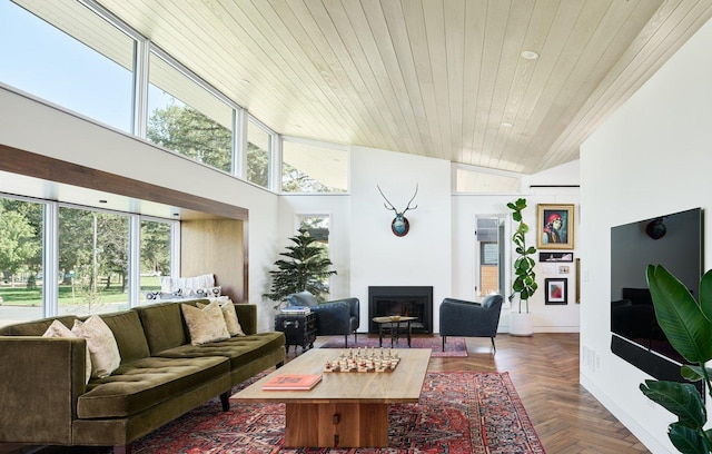 living area with a fireplace, wood ceiling, and a high ceiling