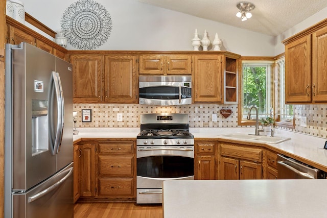 kitchen featuring appliances with stainless steel finishes, a sink, open shelves, tasteful backsplash, and lofted ceiling
