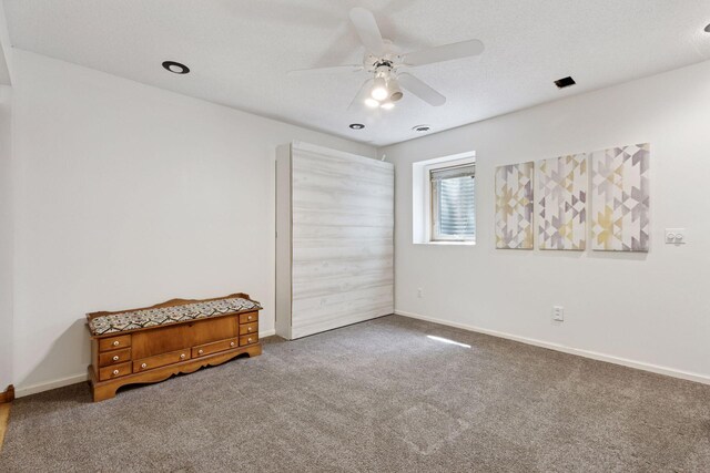 empty room featuring carpet flooring, ceiling fan, and baseboards