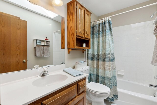 full bathroom with toilet, shower / tub combo, a skylight, and vanity