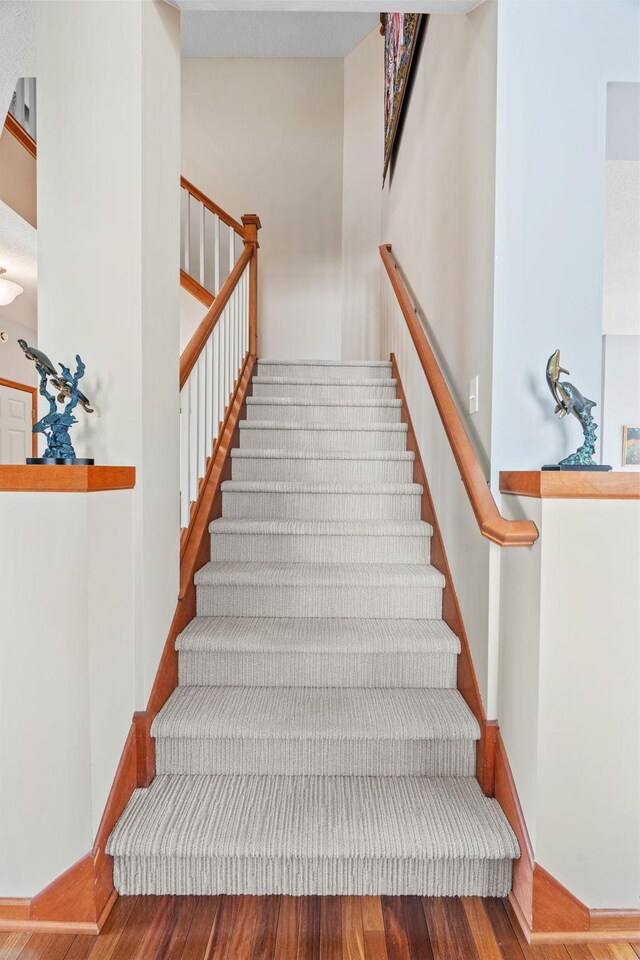 stairs featuring baseboards and wood finished floors
