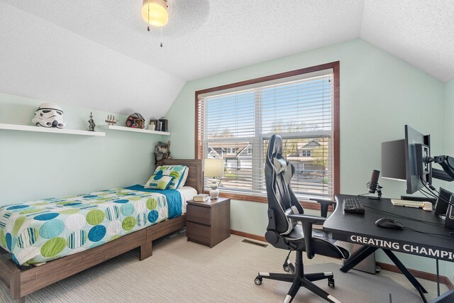 bedroom with light carpet, vaulted ceiling, a textured ceiling, and visible vents
