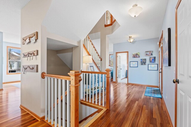 foyer with baseboards and hardwood / wood-style floors