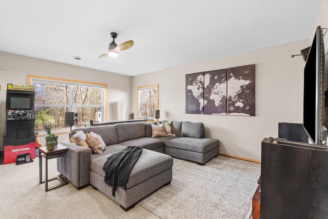 carpeted living area featuring baseboards