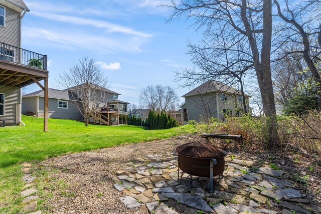 view of patio featuring an outdoor fire pit and a wooden deck