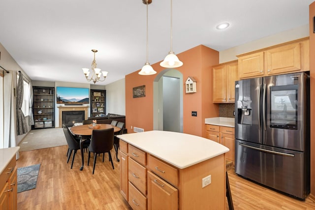 1810 Cherry Cir, Carver, MN 55315 - kitchen with stainless steel refrigerator with ice dispenser, arched walkways, light wood finished floors, a center island, and light countertops