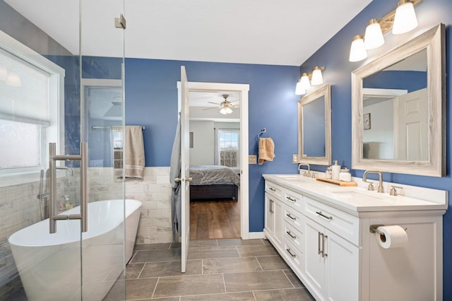 1810 Cherry Cir, Carver, MN 55315 - bathroom featuring tile walls, double vanity, a soaking tub, a ceiling fan, and ensuite bath