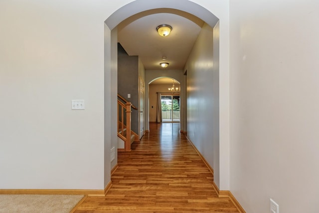 1810 Cherry Cir, Carver, MN 55315 - corridor featuring arched walkways, light wood-type flooring, and stairway