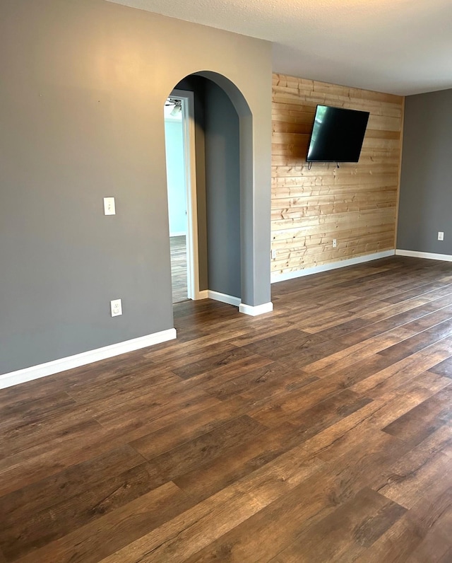 1810 Cherry Cir, Carver, MN 55315 - empty room with arched walkways and dark wood-type flooring