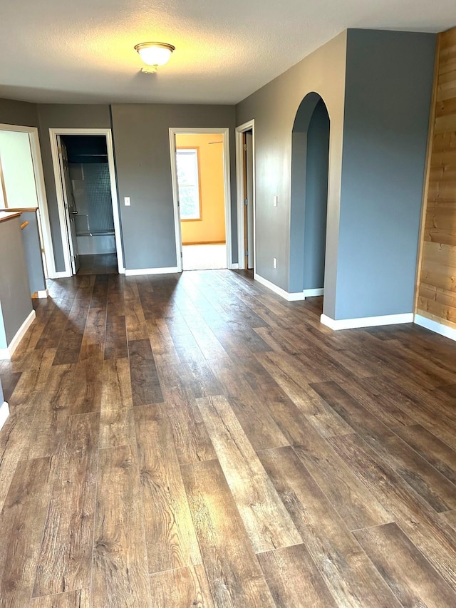 1810 Cherry Cir, Carver, MN 55315 - spare room with wood-type flooring, arched walkways, and a textured ceiling