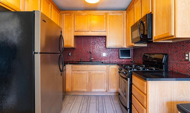 4415 Chowen Ave S Unit 201, Minneapolis, MN 55410 - kitchen featuring appliances with stainless steel finishes, a sink, backsplash, and light wood-style flooring