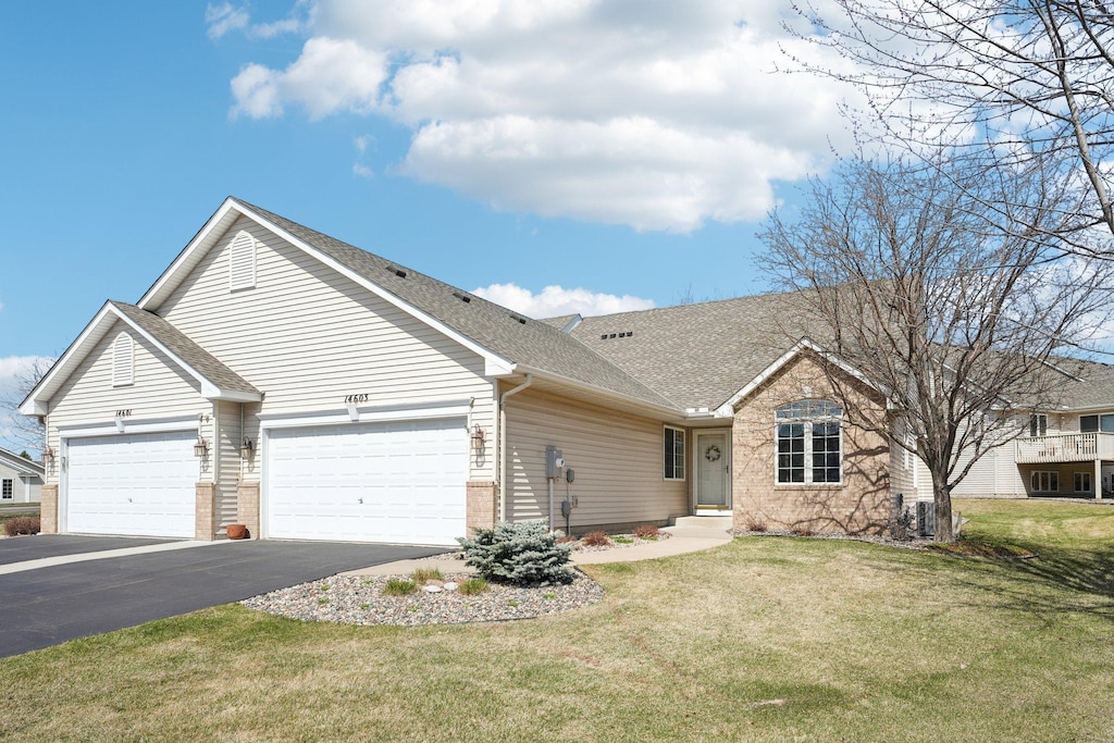 14603 Beverley Ln, Savage, MN 55378 - ranch-style house featuring a front lawn, driveway, an attached garage, brick siding, and roof with shingles