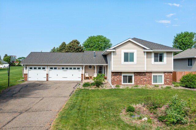 14445 Europa Ave, Apple Valley, MN 55124 - split level home with driveway, brick siding, and an attached garage