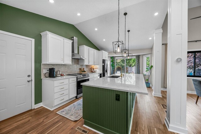 14445 Europa Ave, Apple Valley, MN 55124 - kitchen with appliances with stainless steel finishes, wall chimney range hood, a sink, lofted ceiling, and white cabinets