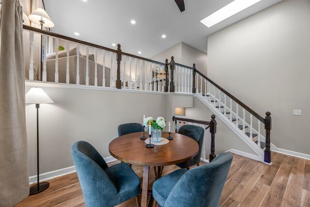 14445 Europa Ave, Apple Valley, MN 55124 - dining area featuring a skylight, wood finished floors, baseboards, recessed lighting, and stairs