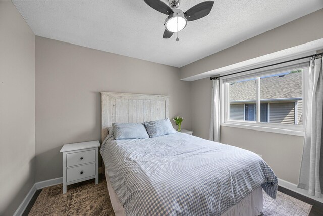 14445 Europa Ave, Apple Valley, MN 55124 - bedroom with baseboards, ceiling fan, and a textured ceiling