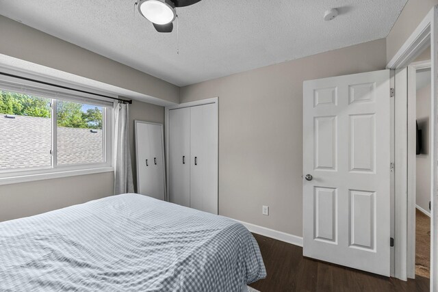 14445 Europa Ave, Apple Valley, MN 55124 - bedroom with baseboards, dark wood-type flooring, a textured ceiling, a closet, and ceiling fan