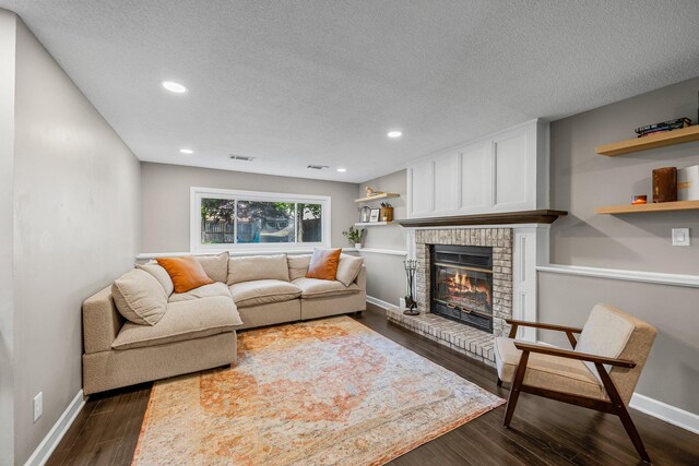 14445 Europa Ave, Apple Valley, MN 55124 - living area with a brick fireplace, dark wood finished floors, a textured ceiling, recessed lighting, and baseboards
