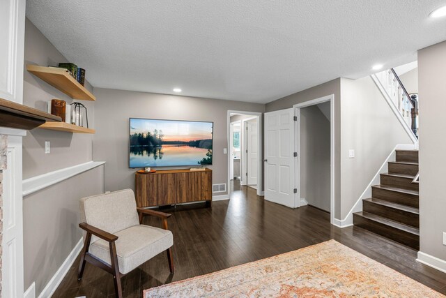 14445 Europa Ave, Apple Valley, MN 55124 - living area with dark wood-style floors, baseboards, stairs, recessed lighting, and a textured ceiling