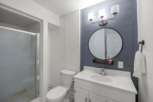 14445 Europa Ave, Apple Valley, MN 55124 - bathroom with toilet, a textured ceiling, a stall shower, vanity, and baseboards