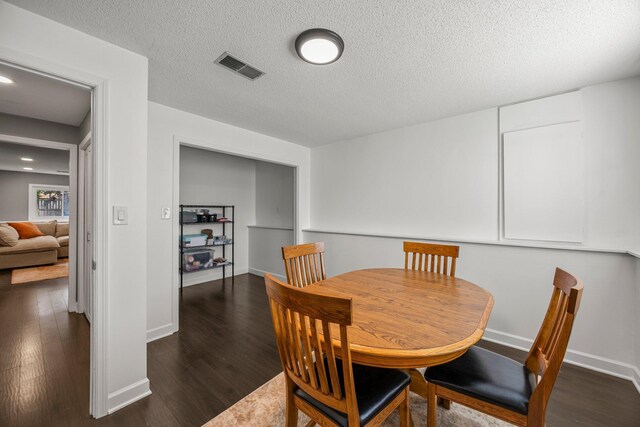 14445 Europa Ave, Apple Valley, MN 55124 - dining room featuring wood finished floors, a textured ceiling, and baseboards