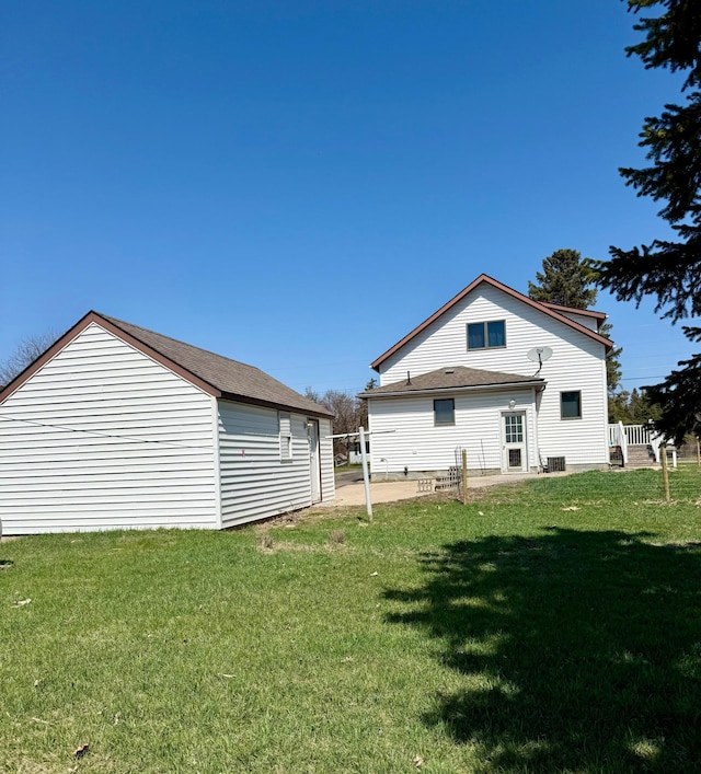 302 Church St, Saint Leo, MN 56264 - back of property featuring a lawn, a patio area, and central AC