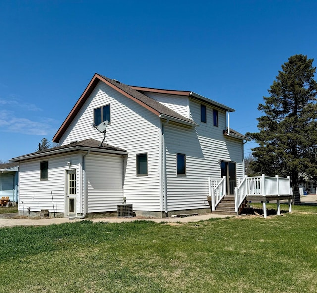 302 Church St, Saint Leo, MN 56264 - back of house featuring a shingled roof, a yard, and a deck