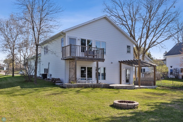back of house with a pergola, fence, a fire pit, and a lawn