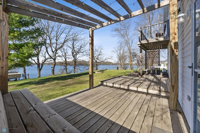 wooden terrace with a yard, a pergola, and a water view