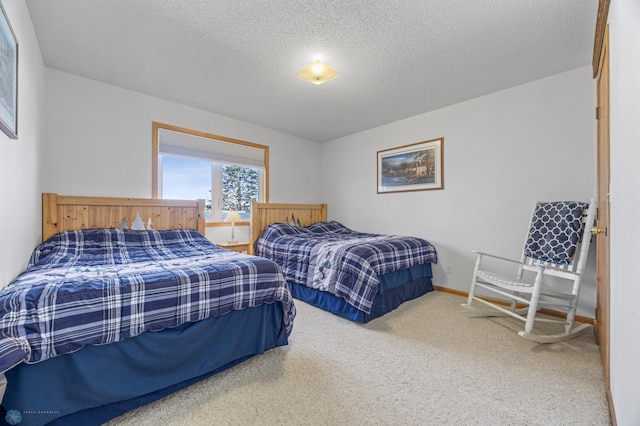 carpeted bedroom featuring a textured ceiling