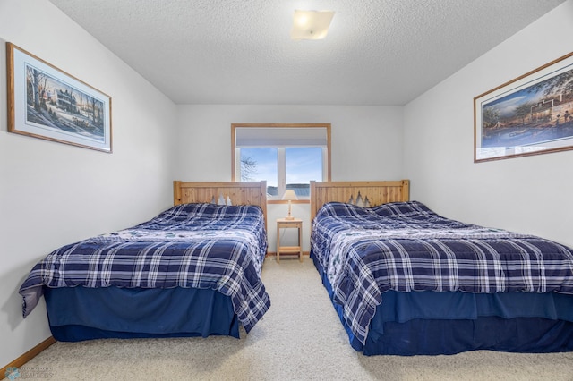 bedroom with a textured ceiling and carpet flooring