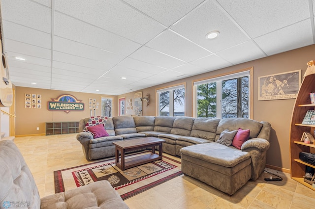 living area featuring recessed lighting, baseboards, and a paneled ceiling
