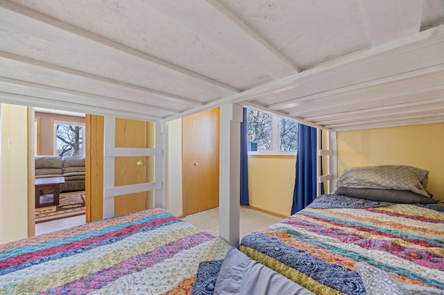 bedroom featuring carpet flooring and beam ceiling