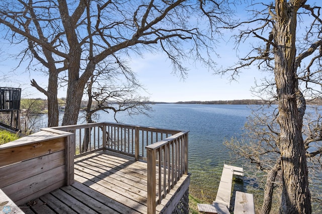wooden deck featuring a water view