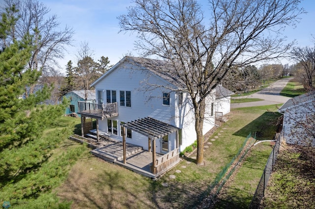 back of house featuring a pergola, a deck, fence, and a yard