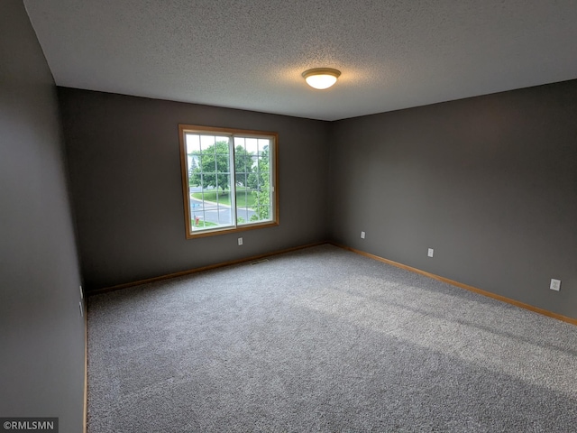 18061 96th Ave N, Maple Grove, MN 55311 - carpeted spare room with a textured ceiling and baseboards