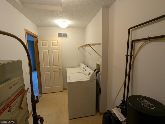 18061 96th Ave N, Maple Grove, MN 55311 - washroom featuring a textured ceiling, washing machine and dryer, and light tile patterned floors