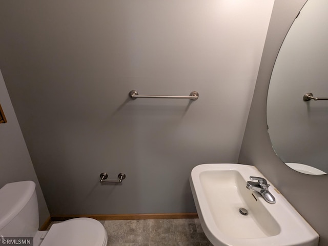 18061 96th Ave N, Maple Grove, MN 55311 - bathroom featuring toilet, baseboards, and a sink