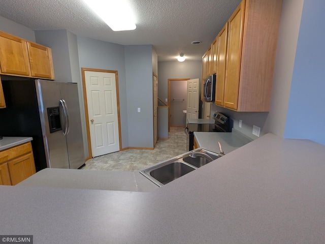 18061 96th Ave N, Maple Grove, MN 55311 - kitchen with stainless steel appliances, a sink, a textured ceiling, and light countertops